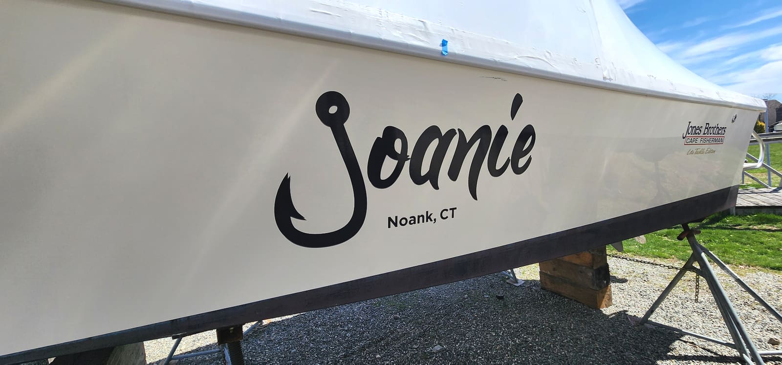 Custom fish hook typography boat name graphics on a transom