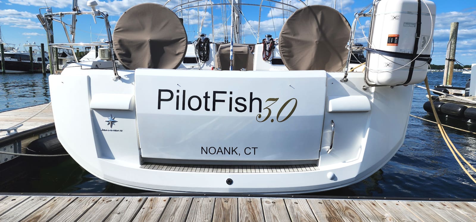 Modern boat name lettering with gold accents on a boat transom